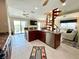Open-concept kitchen with stainless steel appliances and a spiral staircase leading to the upper level at 9580 Almirate Ct, Placida, FL 33946