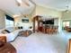 Expansive living room with a spiral staircase and kitchen island with bar seating in an open layout at 9580 Almirate Ct, Placida, FL 33946