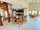 Inviting living area with spiral staircase, kitchen island, and adjacent dining space, all bathed in sunlight at 9580 Almirate Ct, Placida, FL 33946