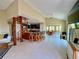 Open-concept living room with spiral staircase, kitchen island, and dining area with natural light at 9580 Almirate Ct, Placida, FL 33946