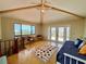 Living room with vaulted ceilings, exposed beams, and doors leading to a deck at 9580 Almirate Ct, Placida, FL 33946