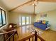 Living room with vaulted ceilings, exposed beams, and doors leading to a deck at 9580 Almirate Ct, Placida, FL 33946