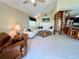 Bright and airy living area with white sofas, wooden staircase, and kitchen island views at 9580 Almirate Ct, Placida, FL 33946