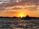 A large boat is silhouetted against the sunset over the water at 9580 Almirate Ct, Placida, FL 33946