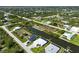 Aerial view of a community on a canal system with docks and screened pools at 10115 Long Branch St, Port Charlotte, FL 33981