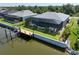 This aerial view highlights the house's location, pool, dock, screened lanai, and landscaping at 10115 Long Branch St, Port Charlotte, FL 33981