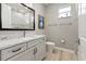 Updated bathroom with wood-look tile floors, a tub/shower combo, and a marble countertop vanity at 10115 Long Branch St, Port Charlotte, FL 33981