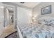 Bedroom featuring a white bed frame, patterned bedding, closet, and hall access at 10115 Long Branch St, Port Charlotte, FL 33981