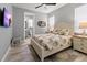 Bedroom featuring light neutral colors, patterned bedding, and an en suite bathroom at 10115 Long Branch St, Port Charlotte, FL 33981