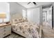 Light and airy bedroom with neutral tones, patterned bedding, and closet at 10115 Long Branch St, Port Charlotte, FL 33981