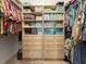 Organized walk-in closet with built-in shelving, drawers, and ample hanging space for clothes and accessories at 10115 Long Branch St, Port Charlotte, FL 33981