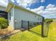 Home exterior showing the side of the property, fence, and landscaping at 10115 Long Branch St, Port Charlotte, FL 33981