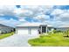 Beautiful single-story home with a well-manicured lawn, stone driveway, and a charming facade with a double garage at 10115 Long Branch St, Port Charlotte, FL 33981