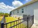 Home exterior showing the side of the property, fence, and landscaping at 10115 Long Branch St, Port Charlotte, FL 33981