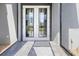 Close up of a modern front door with glass inserts and stone entryway at 10115 Long Branch St, Port Charlotte, FL 33981