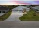 Beautiful single Gathering home featuring a three car garage, paver driveway, and well-manicured lawn at 10115 Long Branch St, Port Charlotte, FL 33981