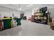 Spacious garage featuring epoxy flooring and ample storage, perfect for organization and vehicle parking at 10115 Long Branch St, Port Charlotte, FL 33981