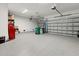 Spacious three-car garage with epoxy flooring and ample storage space at 10115 Long Branch St, Port Charlotte, FL 33981