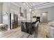 Modern kitchen with a large center island, stainless steel appliances, and wood-look flooring at 10115 Long Branch St, Port Charlotte, FL 33981