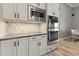 A clean, modern kitchen with stainless steel appliances, white cabinets, and beautiful marble backsplash at 10115 Long Branch St, Port Charlotte, FL 33981