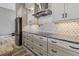 Well-equipped kitchen featuring a pot filler, sleek countertops, and stainless steel appliances at 10115 Long Branch St, Port Charlotte, FL 33981