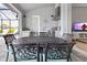 Outdoor kitchen with a grill, sink, refrigerator, and dining table at 10115 Long Branch St, Port Charlotte, FL 33981