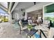 Inviting outdoor living area features a full kitchen, dining set, and comfortable seating at 10115 Long Branch St, Port Charlotte, FL 33981