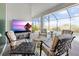 Inviting outdoor seating area with a view of the pool and a mounted flat-screen TV at 10115 Long Branch St, Port Charlotte, FL 33981