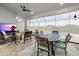 Relaxing outdoor patio with a dining area, comfortable seating, and views of the pool and backyard at 10115 Long Branch St, Port Charlotte, FL 33981