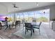 Outdoor patio featuring a dining table, comfortable seating, and a screened-in pool at 10115 Long Branch St, Port Charlotte, FL 33981