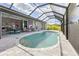 Sparkling pool with a screen enclosure, outdoor dining, and a view of the house at 10115 Long Branch St, Port Charlotte, FL 33981