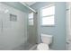 Bathroom featuring tiled shower, window, and tiled floor at 10164 Stonecrop Ave, Englewood, FL 34224