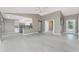 Open-concept living space blending the living room and kitchen with lots of natural light and tile floors at 10164 Stonecrop Ave, Englewood, FL 34224
