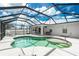 Relaxing screened-in pool with ample patio space, ideal for outdoor lounging and entertaining friends at 10164 Stonecrop Ave, Englewood, FL 34224