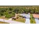 Aerial view of a well-kept home with a screened-in pool, lush landscaping, and waterfront access at 10182 Charlemont Ave, Englewood, FL 34224
