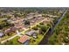 Aerial view of property highlighting the home, pool, and canal frontage in a residential neighborhood at 10182 Charlemont Ave, Englewood, FL 34224