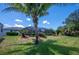 View of the spacious backyard, pool, and house at 10182 Charlemont Ave, Englewood, FL 34224