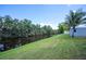 Scenic backyard view of canal with lush greenery and shed, perfect for relaxation and waterfront living at 10182 Charlemont Ave, Englewood, FL 34224