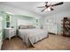 Bright bedroom with a ceiling fan, windows, and furnishings, offering a comfortable space at 10182 Charlemont Ave, Englewood, FL 34224