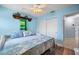 Light and bright bedroom featuring a ceiling fan, closet, and decorative accents at 10182 Charlemont Ave, Englewood, FL 34224