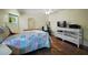 Cozy bedroom featuring hardwood floors, ample natural light, and a comfortable layout at 10182 Charlemont Ave, Englewood, FL 34224