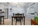 Well-lit dining room with stainless steel appliances and adjacent breakfast bar at 10182 Charlemont Ave, Englewood, FL 34224