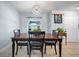 Inviting dining room with decorative chandelier and a view of the front entrance at 10182 Charlemont Ave, Englewood, FL 34224