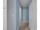 Hallway showcasing tiled floors, neutral wall color, and closet space at 10182 Charlemont Ave, Englewood, FL 34224