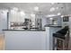 Open kitchen design with a breakfast bar, stainless steel appliances, and pendant lighting at 10182 Charlemont Ave, Englewood, FL 34224