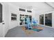 Screened lanai with high-top chairs on a colorful rug overlooking the pool at 10182 Charlemont Ave, Englewood, FL 34224