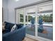 Inviting patio area with comfortable seating, accessible through sliding glass doors from the living room at 10182 Charlemont Ave, Englewood, FL 34224