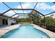 Lovely screened pool with large brick paver deck and shady yard at 10182 Charlemont Ave, Englewood, FL 34224