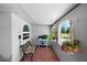 Cozy side porch with bench and decorative plants, perfect for relaxing and enjoying the outdoors at 10182 Charlemont Ave, Englewood, FL 34224
