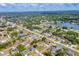 Aerial view of the neighborhood with lush greenery and a tranquil lake at 1035 Riggs St, Port Charlotte, FL 33952